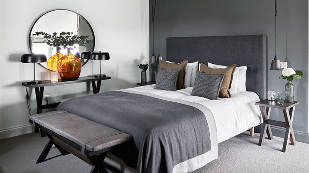 How do you make a grey bedroom look warm?