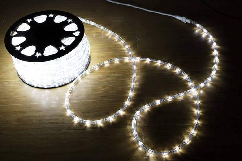 720 LED rope lights unrolled on a garage floor, ready for holiday installation with remote nearby