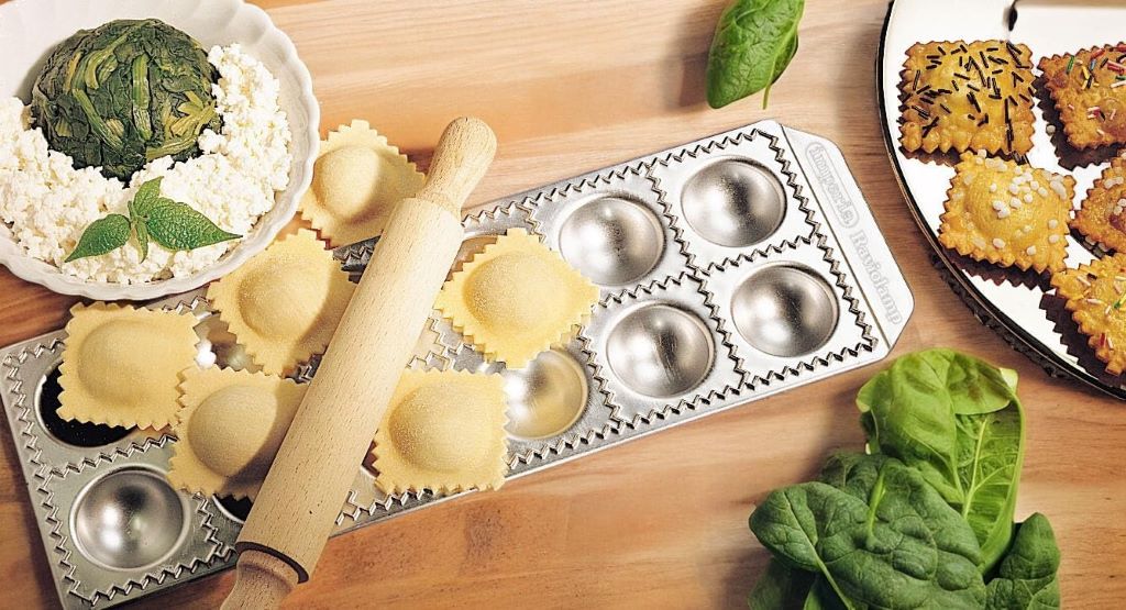 Fresh ravioli formed using the Imperia Ravioli Maker on a kitchen counter.